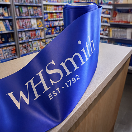 100mm Wide Royal Blue Ribbon Custom Printed for WH Smith with a white logo print for a grand opening by Personalised Printed Ribbons