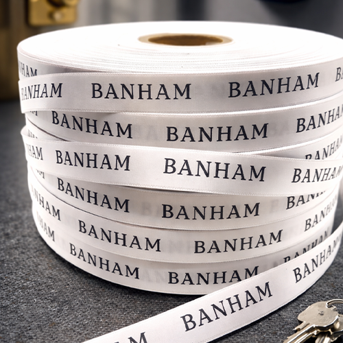 White Ribbon Black Printed Branded For A Security Company by Personalised Printed Ribbons Quick Delivery 01277 224622