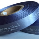 Logo Printed Onto A Dark Grey Ribbon
