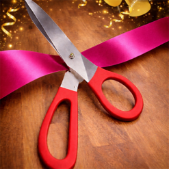 BIG RED HANDLED SCISSORS WITH BRIGHT PINK RIBBON FOR RIBBON CUTTING EVENTS