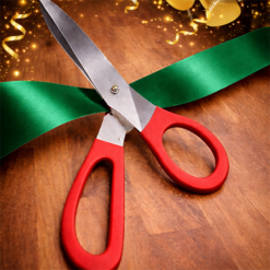 BIG RED HANDLED SCISSORS WITH EMERALD GREEN RIBBON FOR RIBBON CUTTING EVENTS
