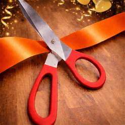 BIG RED HANDLED SCISSORS WITH ORANGE RIBBON FOR RIBBON CUTTING EVENTS