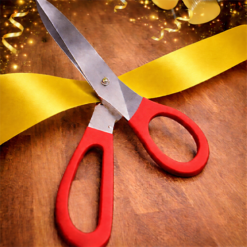 BIG RED HANDLED SCISSORS WITH YELLOW RIBBON FOR RIBBON CUTTING EVENTS