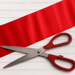 Extra wide red ribbon and giant scissors for ribbon cutting event