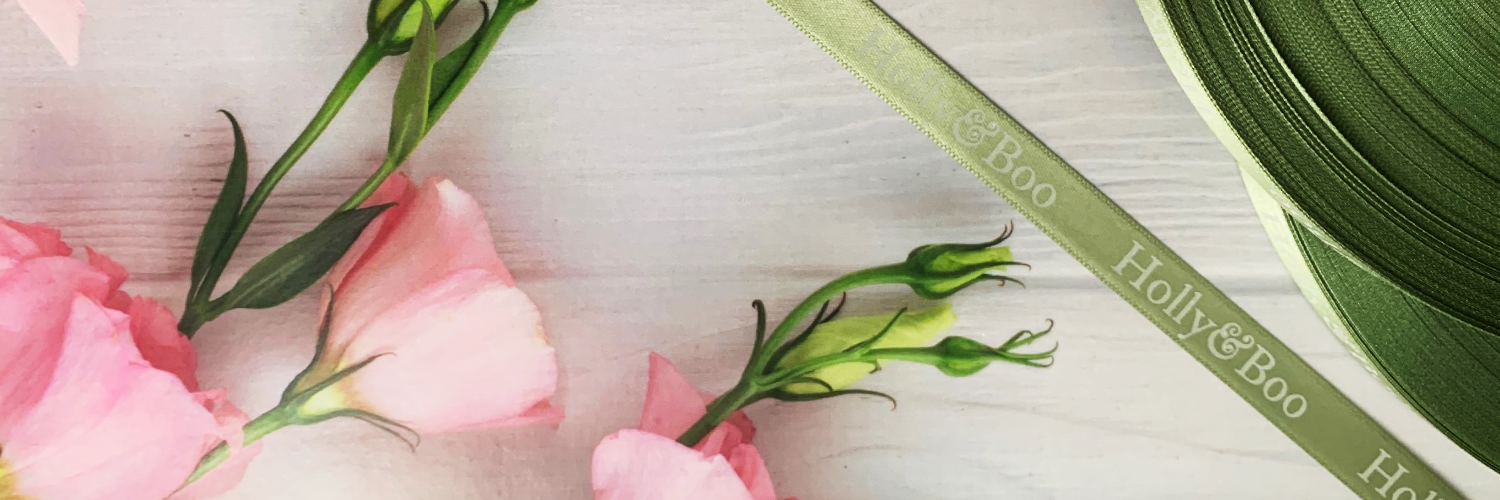 Logo Printed Onto A Sage Green Ribbon