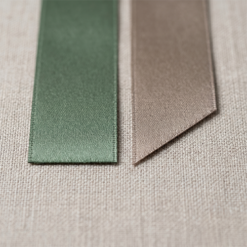 Comparison of straight cut vs 45 degree bevel cut satin ribbon edges showing precision thermal heat-sealing for wedding favours.